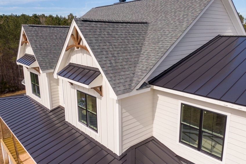Sunny Daytime Drone Images of a Custom Home in the Final Stages of Construction. It Features a Roof 
