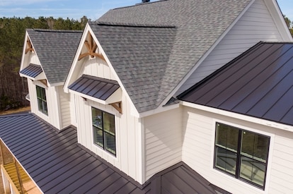Sunny Daytime Drone Images of a Custom Home in the Final Stages of Construction. It Features a Roof 